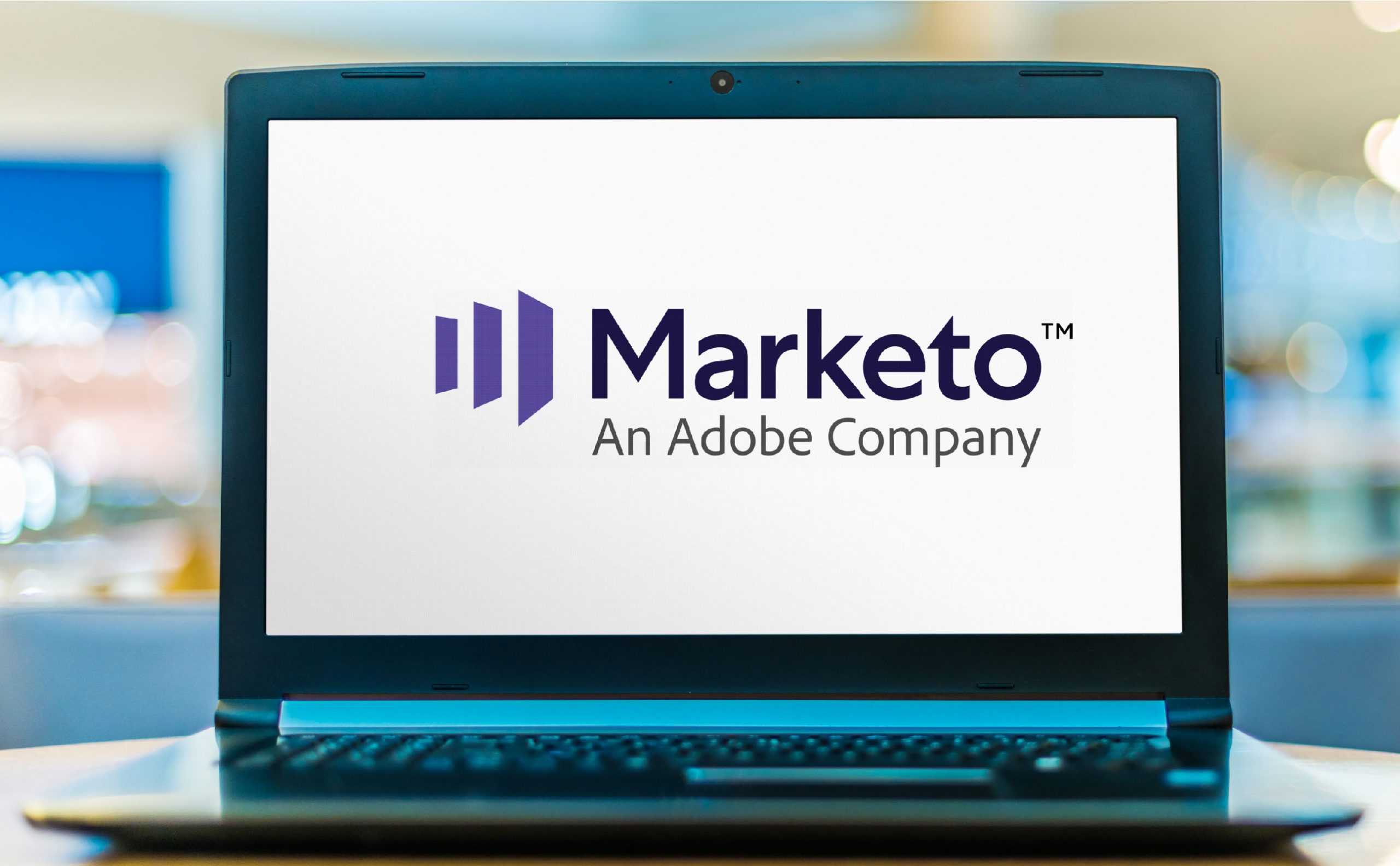 A laptop with the Adobe Marketo logo on its screen.